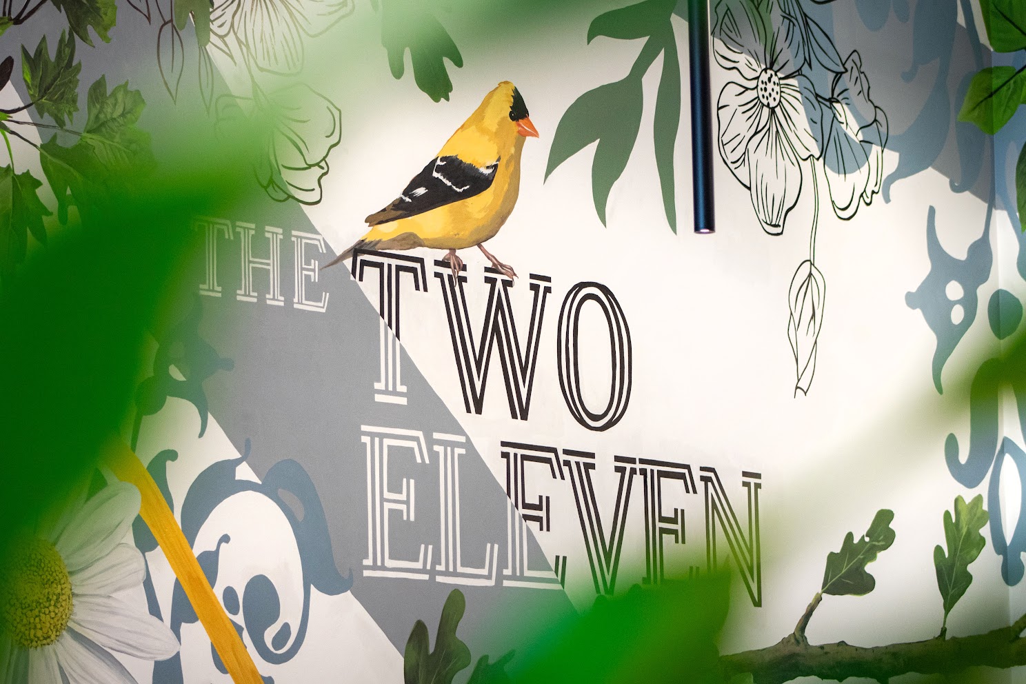 Detailed view of native Ohio flowers and birds painted across the Gathering Garden mural